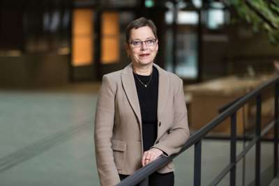 Portrett av Mari Velsand i halvfigur. Hun har på seg en beige blazer med en sort topp i.